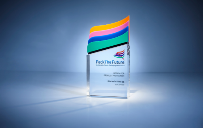 The Pack the Future Award against a dark blue background. The award is in the center of the frame and is illuminated